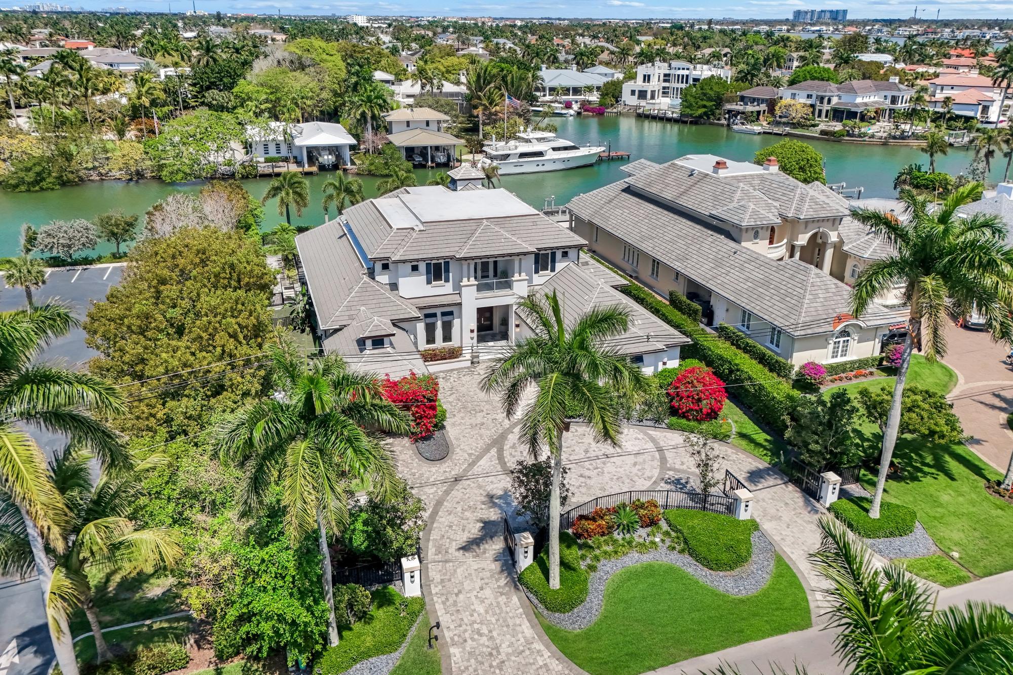 Aerial view of a waterfront estate on a Naples, Florida canal with a private dock